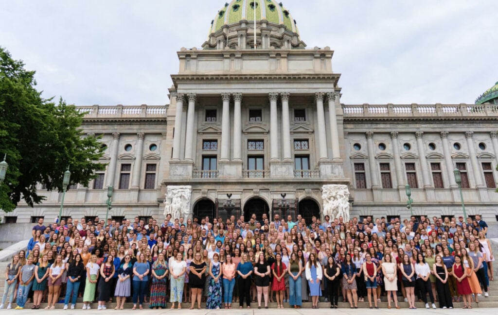 Large group in front of a capitol building.