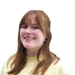 Headshot of a smiling woman, long reddish hair with bangs.