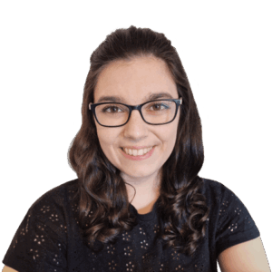 Headshot of smiling woman with black-framed glasses and brunette hair.