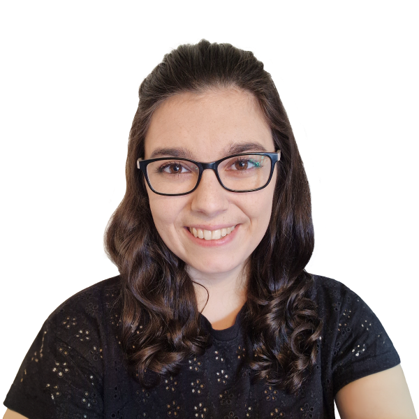 Headshot of smiling woman with black-framed glasses and brunette hair.