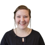 Headshot of a smiling woman with a black blouse.