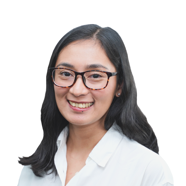 Headshot of smiling woman with black-framed glasses and brunette hair.