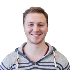 Headshot of a cheerful man in striped hoodie, clear background.