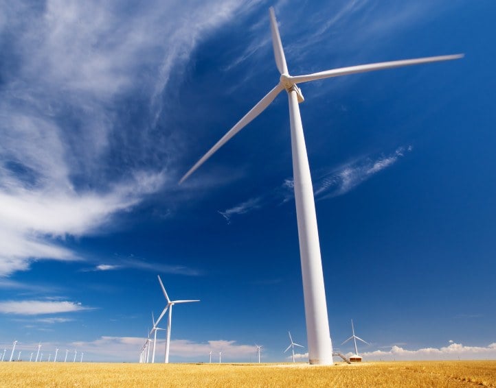 Wind turbines against a clear blue sky.