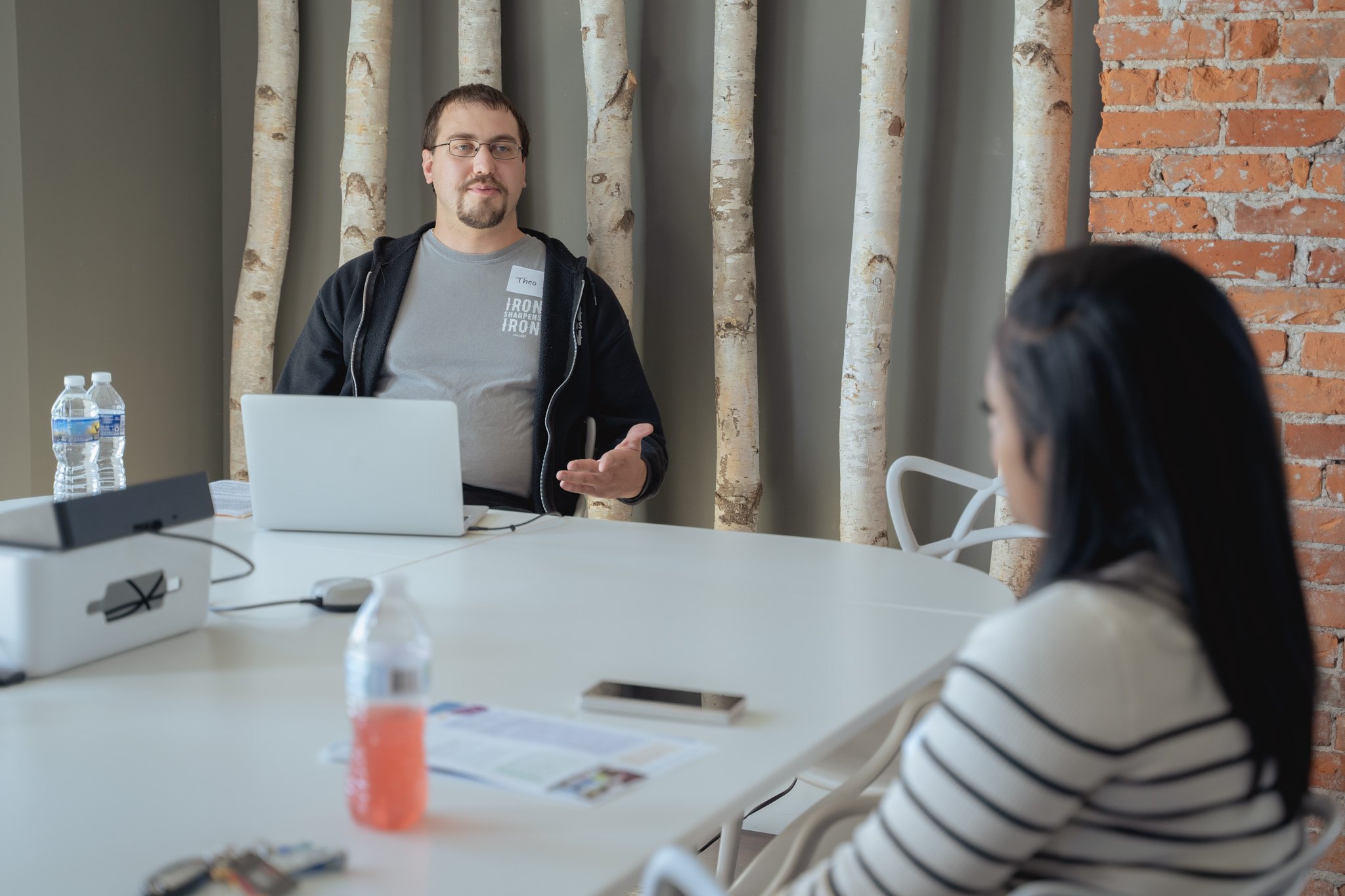 Two people have a conversation in a WebFX conference room