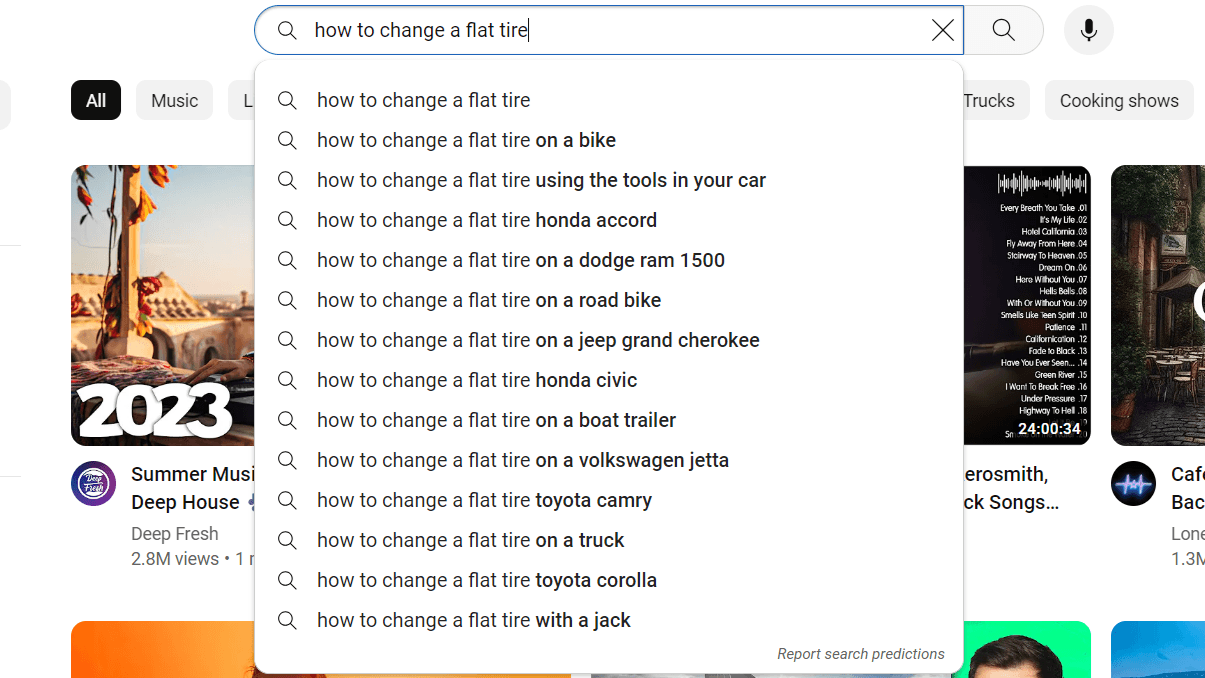 suggested searches for "how to change a flat tire" on YouTube