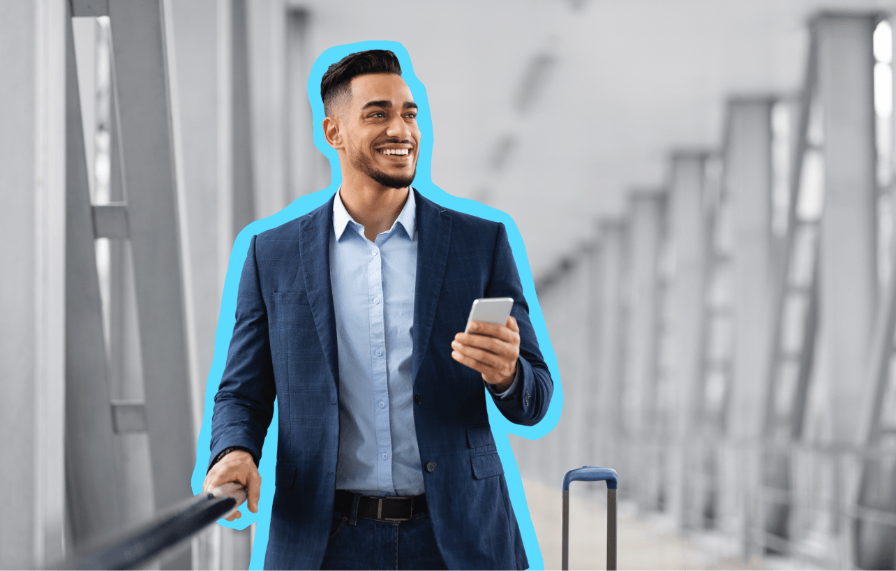 Man in a suit smiling while holding his phone