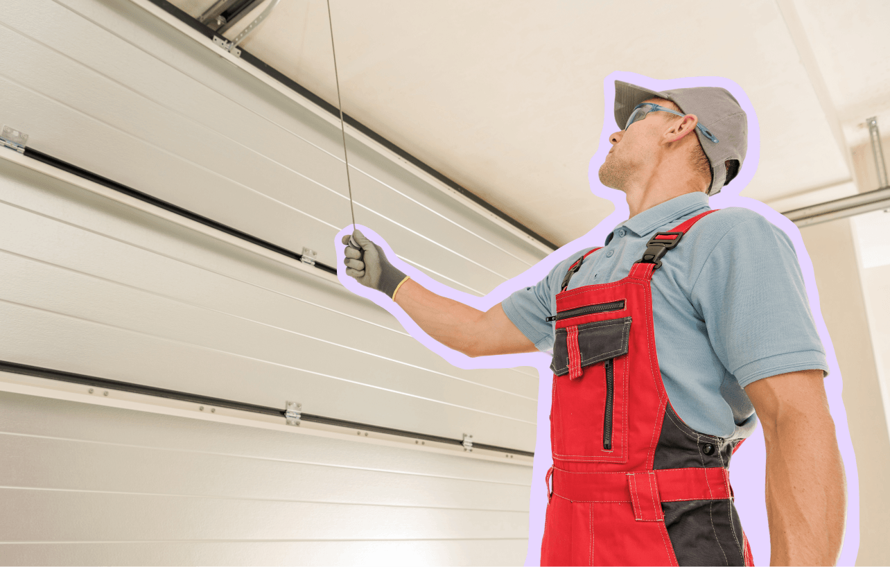 Man working on repairing a garage door