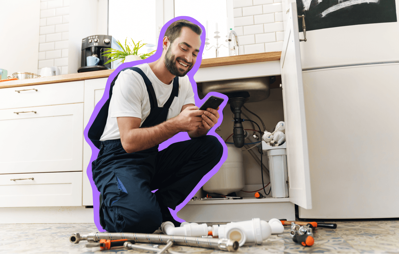 Plumber working under a sink
