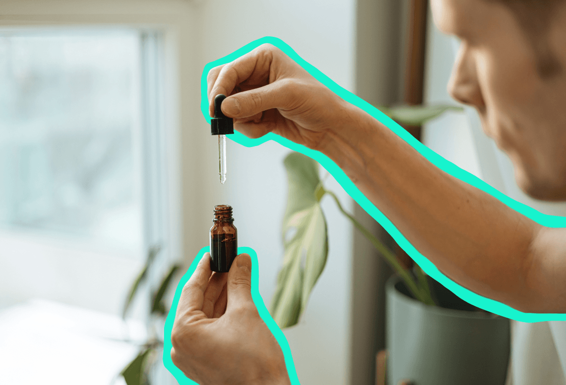 Person using CBD drops