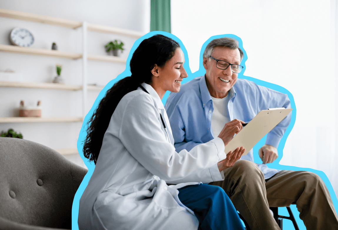 Female doctor sitting next to a male patient discussing information in a file