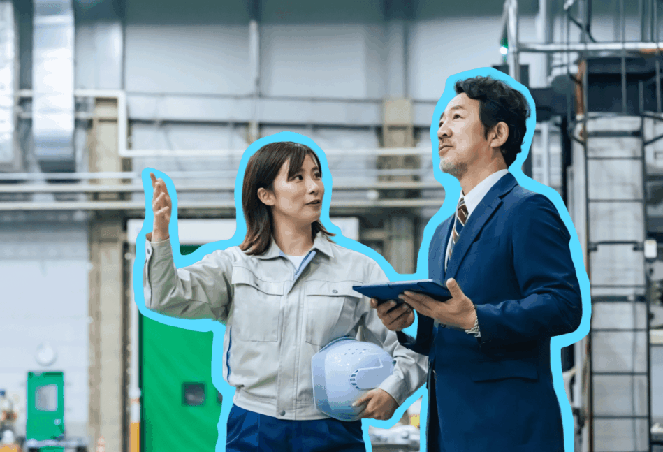 Two people in a factory having a conversation