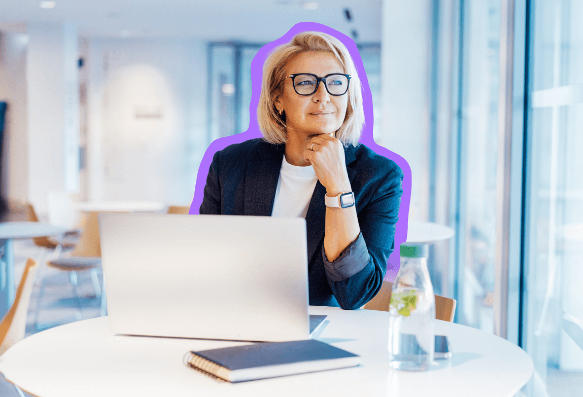 Blonde business woman looking off to the side while on a laptop