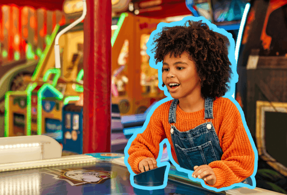 Young black girl playing an arcade game