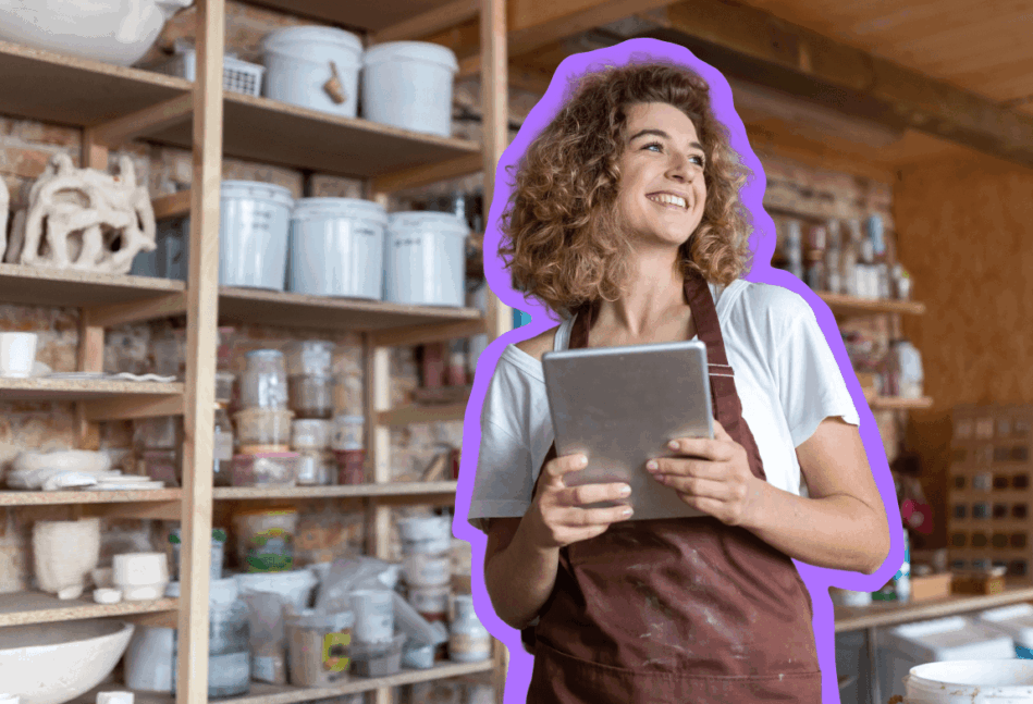 Small business owner standing and smiling in her shop