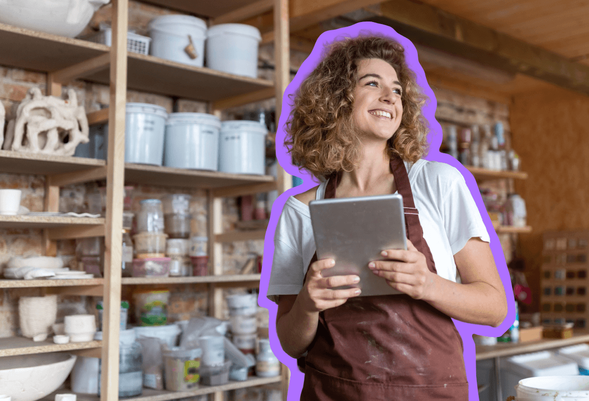 Small business owner standing and smiling in her shop